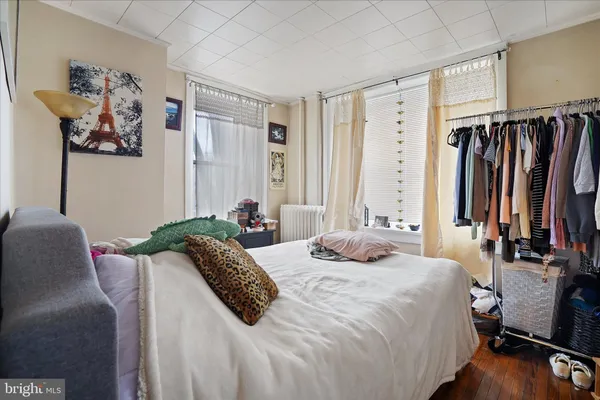 a bedroom with a bed and a couch