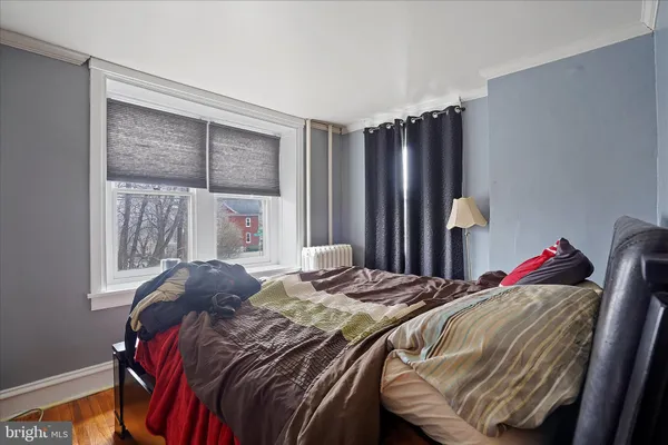 a bed sitting in a bedroom next to a window