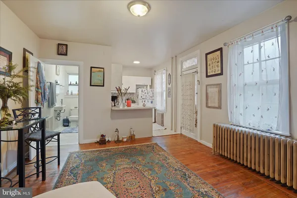a living room with stainless steel appliances kitchen island granite countertop furniture and a refrigerator