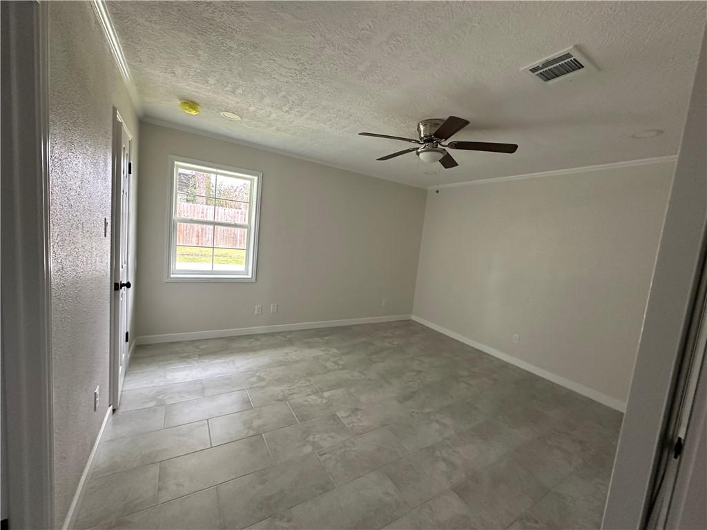 2507 Oak Circle Bryan, TX 77802 - Photo 24 of 34 a view of a livingroom with a ceiling fan and window