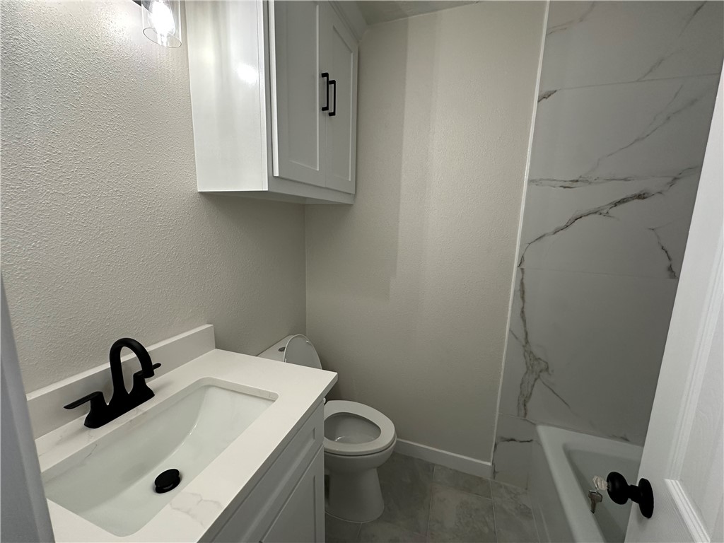 2507 Oak Circle Bryan, TX 77802 - Photo 27 of 34 a bathroom with a sink and mirror with toilet