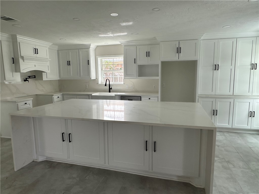2507 Oak Circle Bryan, TX 77802 - Photo 10 of 34 a kitchen with stainless steel appliances granite countertop a sink and white cabinets