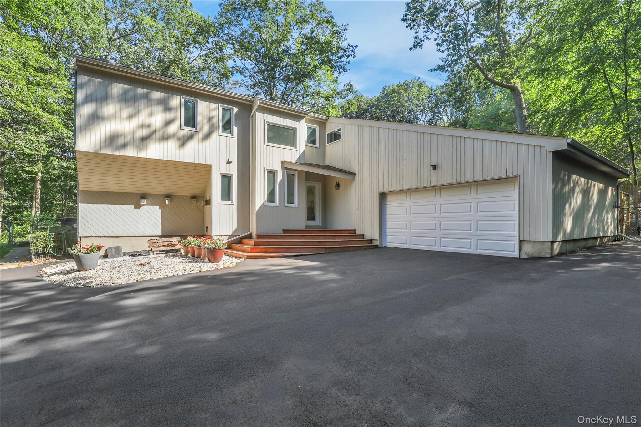 118 Brook Road Port Jefferson, NY 11777 - Photo 1 of 1 Mid-century home featuring an attached garage and driveway