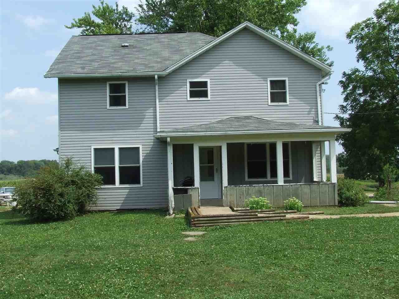 8765 North Lake Road Lena, IL 61048 - Photo 1 of 12 a front view of a house with a garden