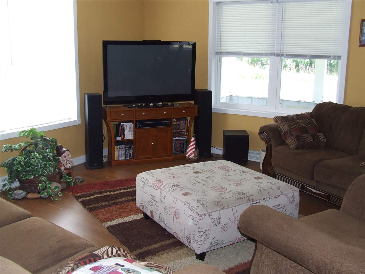 8765 North Lake Road Lena, IL 61048 - Photo 3 of 12 a living room with furniture a flat screen tv and a fireplace