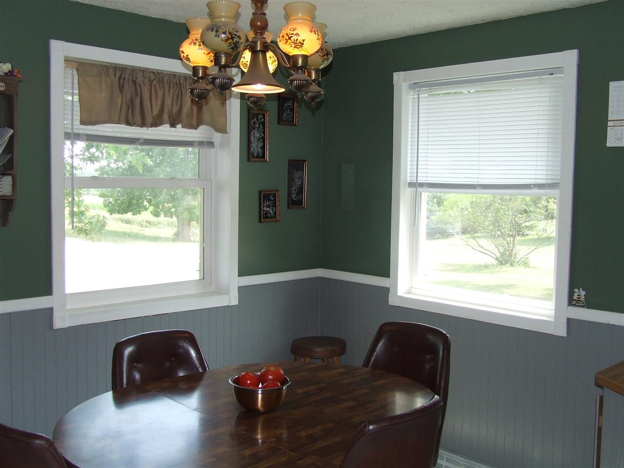 8765 North Lake Road Lena, IL 61048 - Photo 7 of 12 a blue chair sitting in a window next to a window