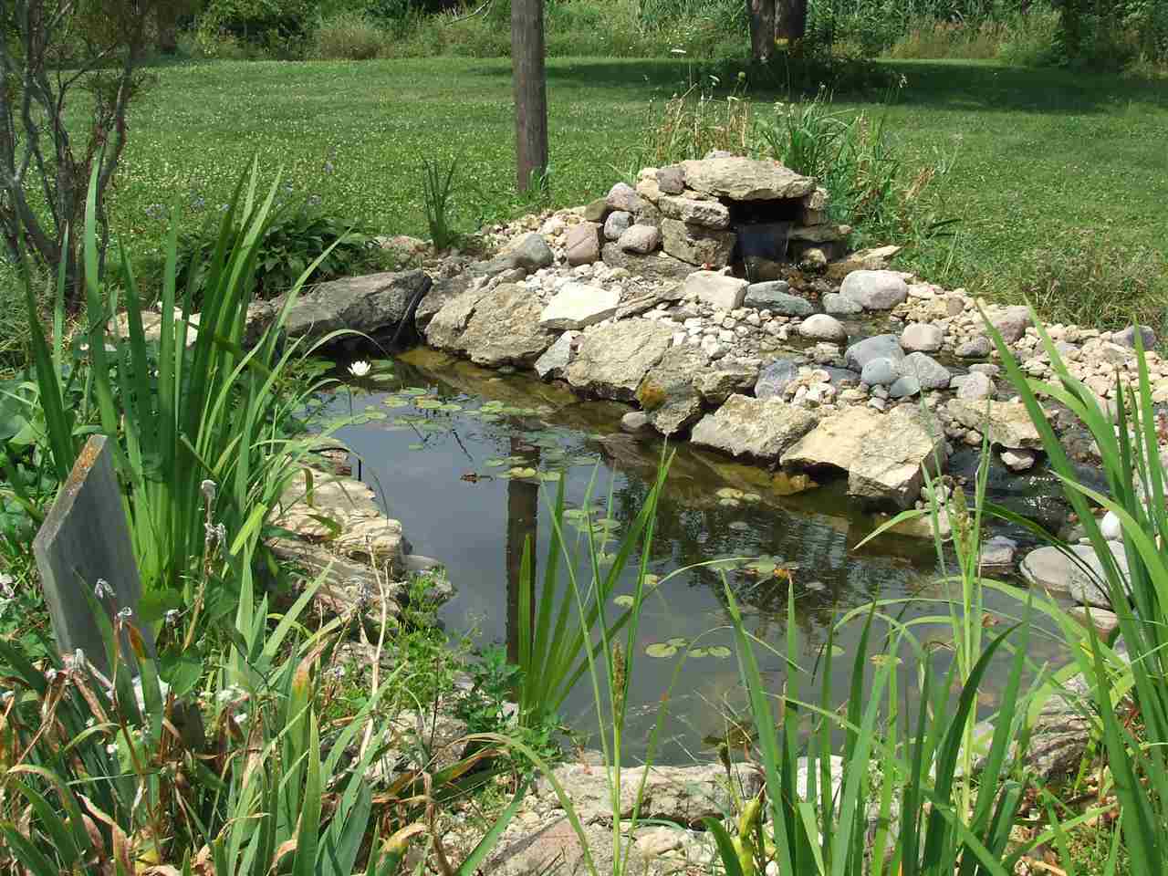 8765 North Lake Road Lena, IL 61048 - Photo 10 of 12 a view of a garden with a lake