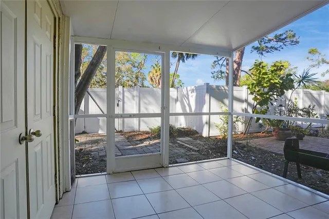 an empty room with wooden floor cabinet and windows