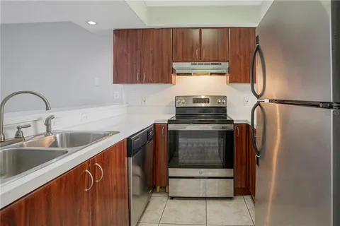 a kitchen with stainless steel appliances a refrigerator and a stove top oven