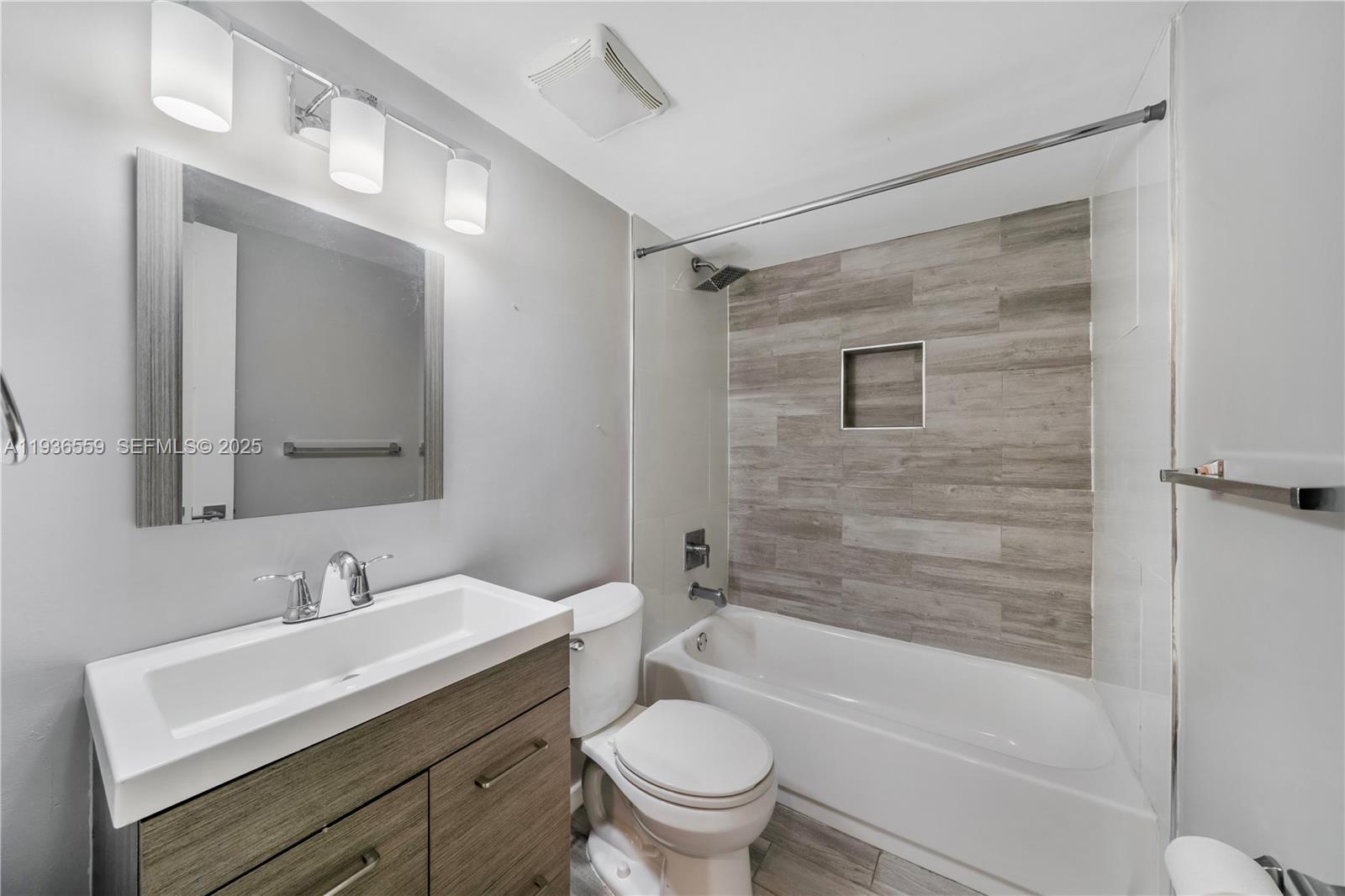 8095 Northwest 8th Street, Unit 412 Miami, FL 33126 - Photo 13 of 20 a bathroom with a sink a toilet and shower