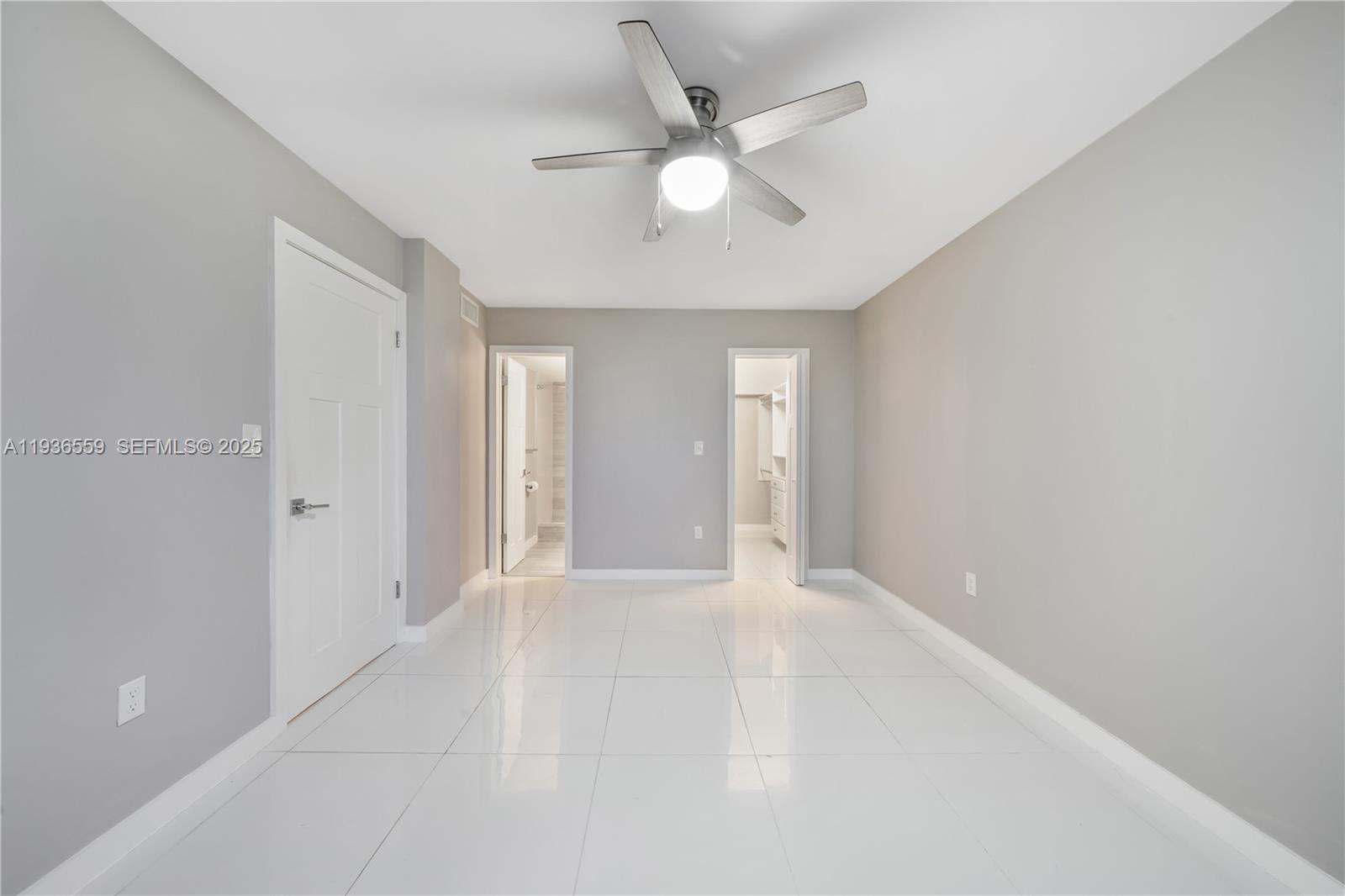 8095 Northwest 8th Street, Unit 412 Miami, FL 33126 - Photo 14 of 20 wooden floor in an empty room with a ceiling fan