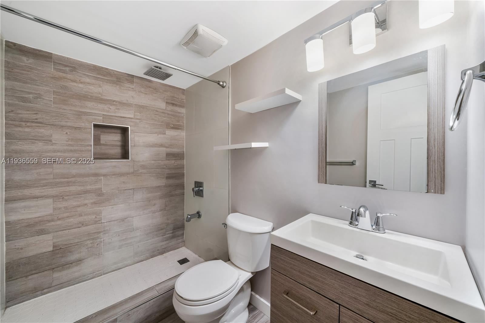 8095 Northwest 8th Street, Unit 412 Miami, FL 33126 - Photo 18 of 20 a bathroom with a sink a toilet and shower