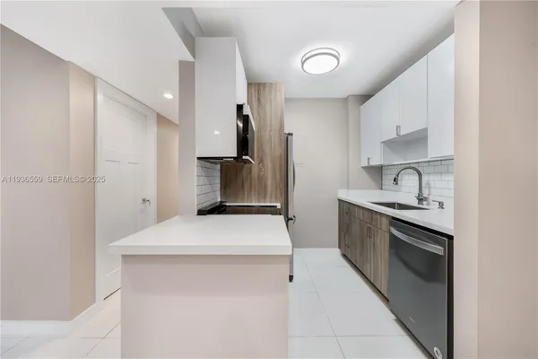 a kitchen with stainless steel appliances a sink stove and refrigerator