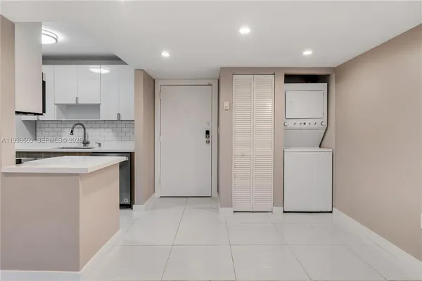 a kitchen with a sink cabinets and a refrigerator