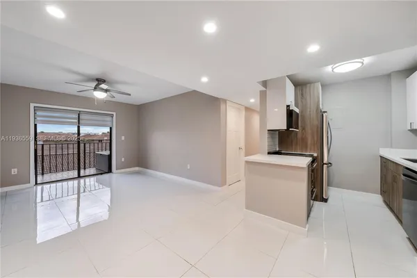 a view of kitchen with refrigerator and window