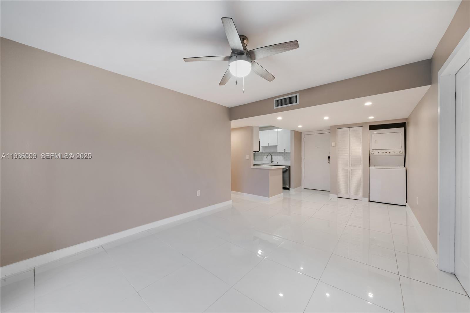 8095 Northwest 8th Street, Unit 412 Miami, FL 33126 - Photo 9 of 20 an empty room with a empty space and a ceiling fan