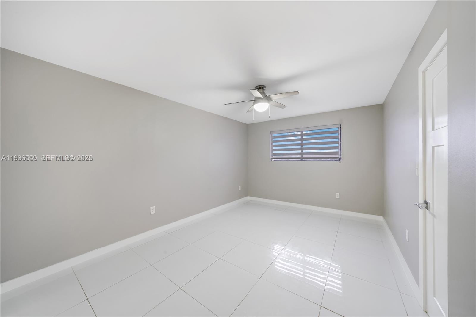8095 Northwest 8th Street, Unit 412 Miami, FL 33126 - Photo 10 of 20 a view of an empty room with a window