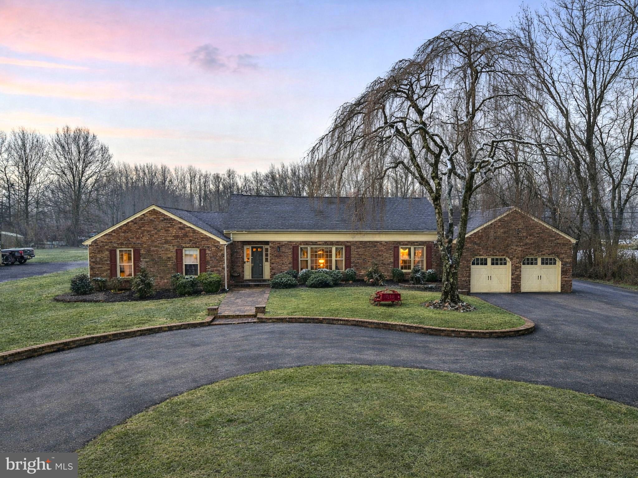 Charming brick home nestled in serene landscape.