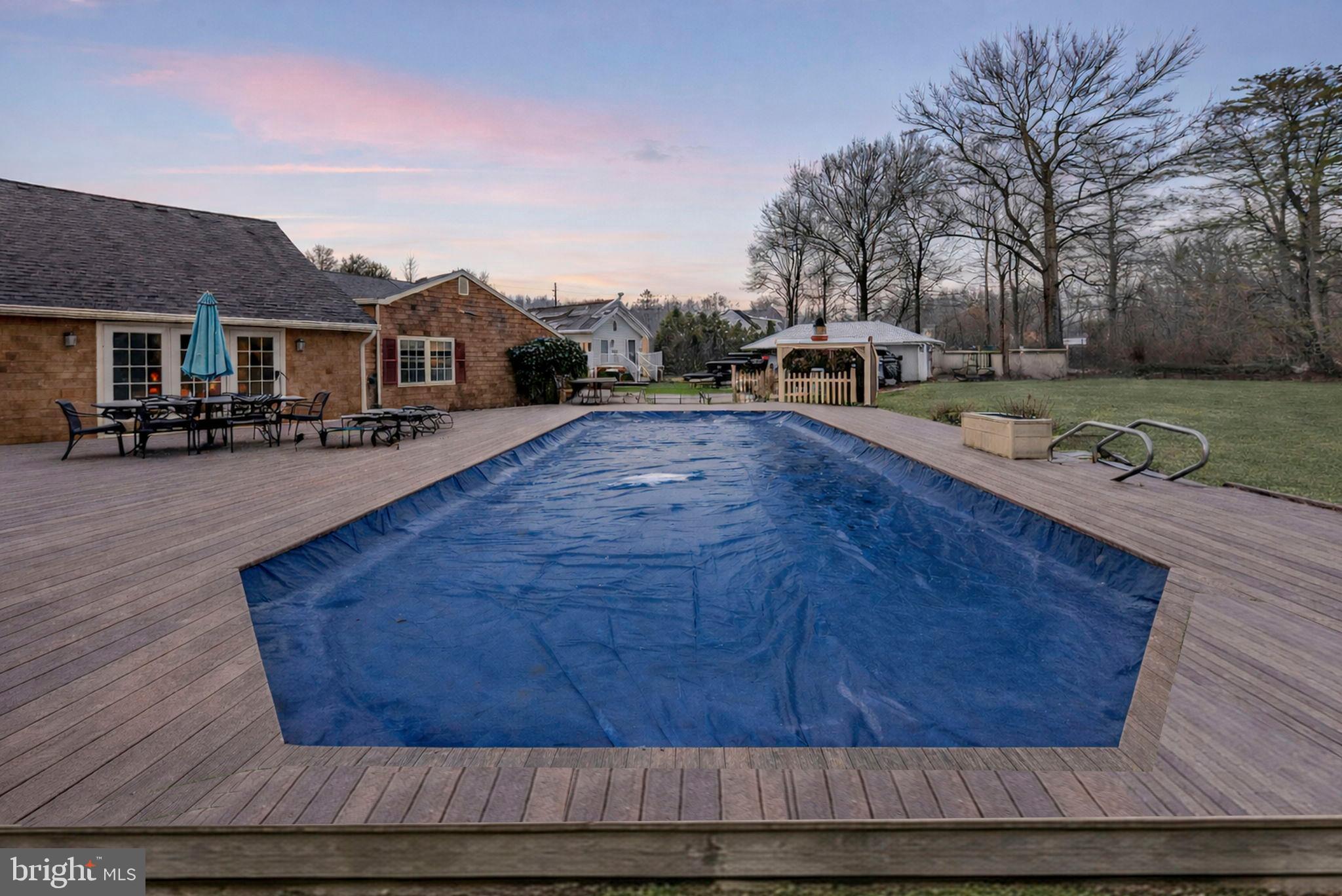 402 Main Street Manalapan, NJ 07726 - Photo 4 of 44 Tranquil backyard oasis with a serene pool.