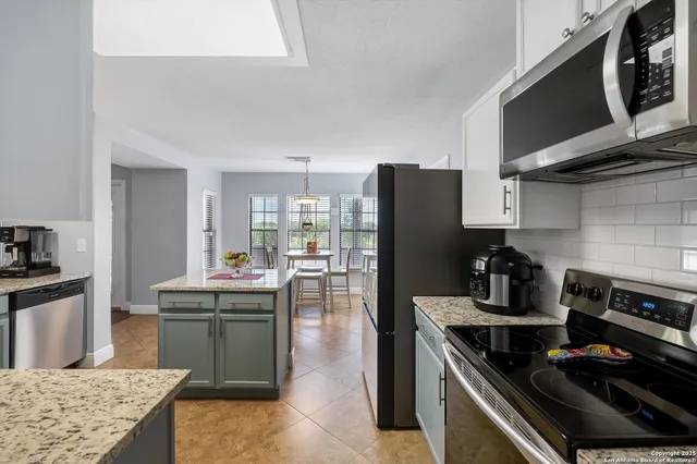a kitchen with a stove and a refrigerator