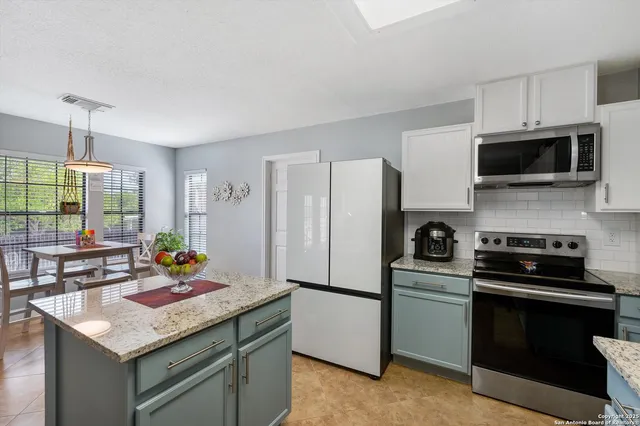 a kitchen with a sink stove and microwave