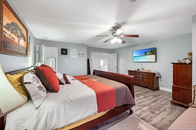 a bedroom with bed and a chandelier