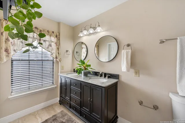 a bathroom with a sink mirror and vanity