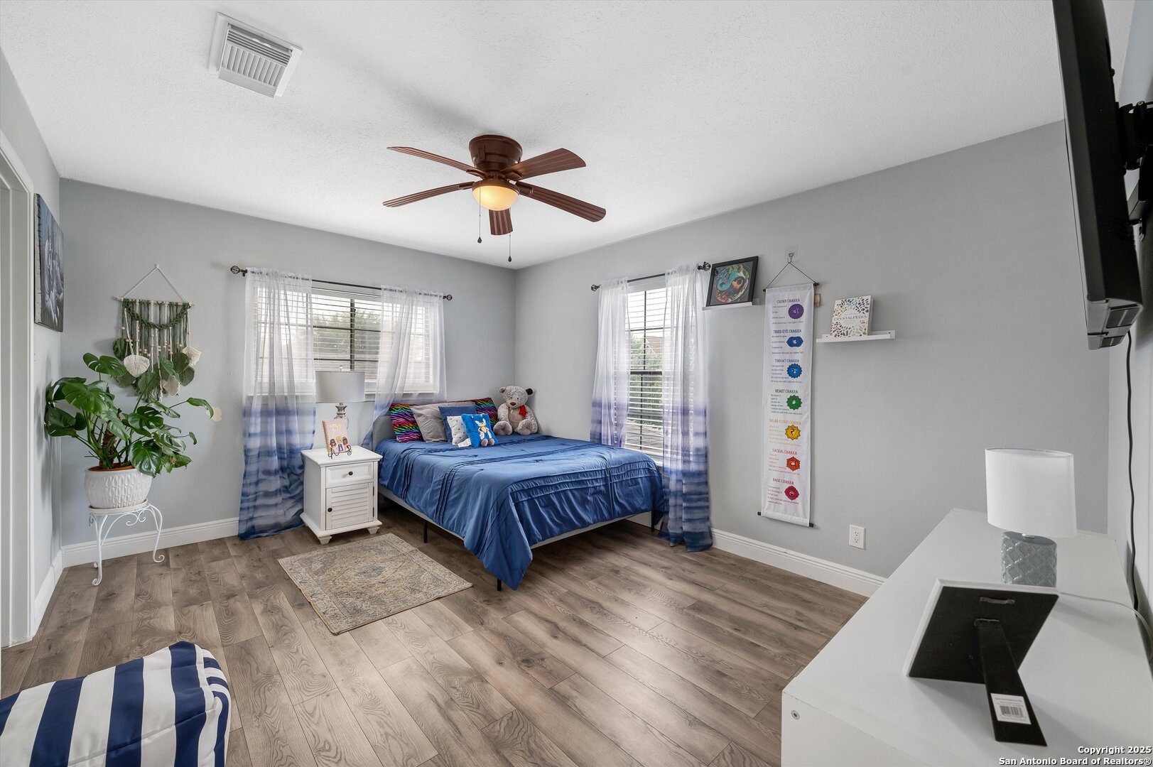 7624 Lonecrest Lane Converse, TX 78109 - Photo 24 of 32 a bedroom with a bed chandelier and a window