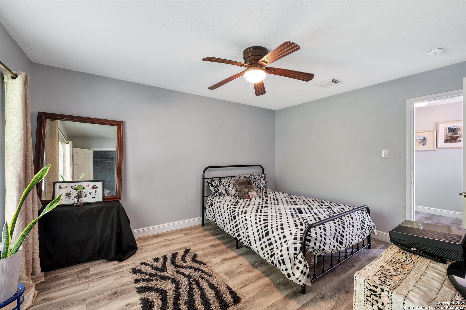 7624 Lonecrest Lane Converse, TX 78109 - Photo 26 of 32 a bedroom with a bed and wooden floor