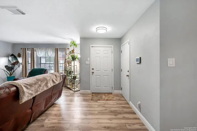 a living room with a bed furniture and next to a window