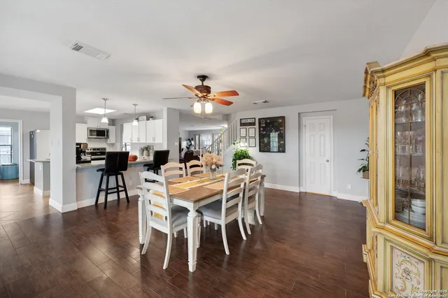 a view of a dining room with furniture and wooden floor