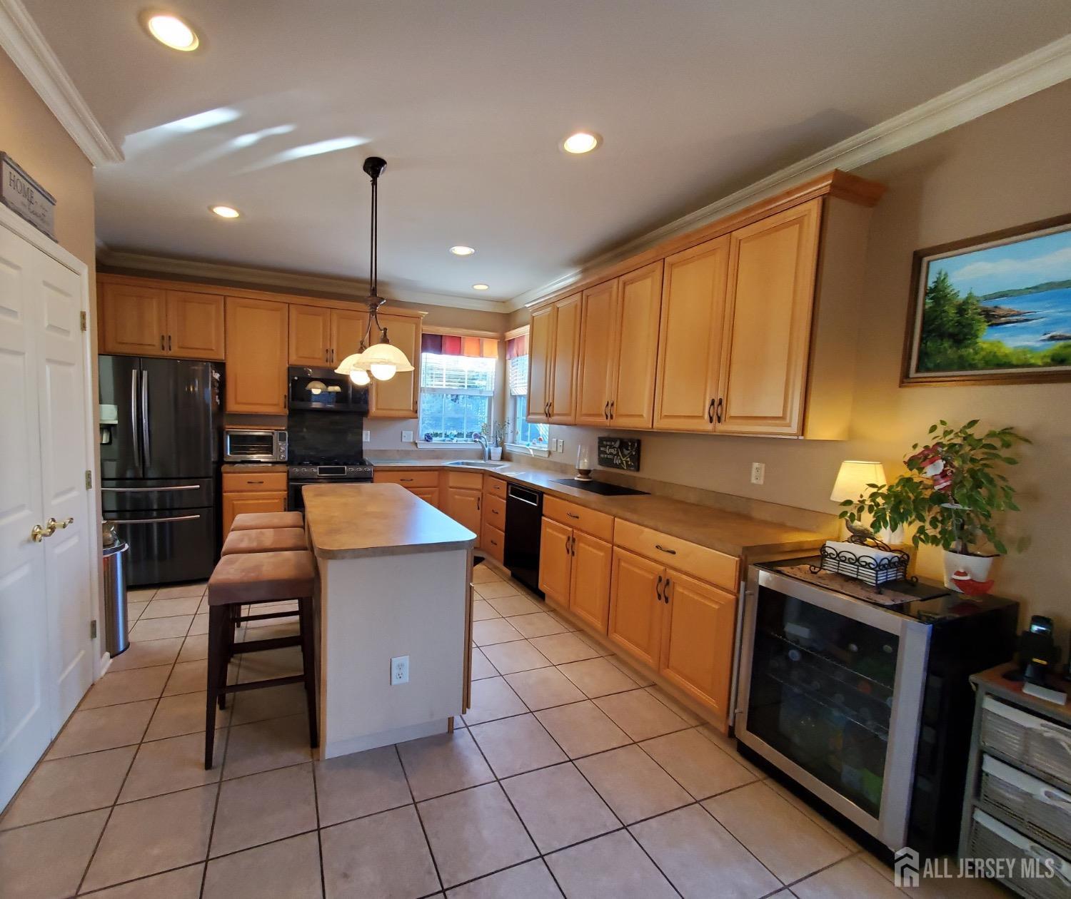 14 Young Way Bridgewater, NJ 08807 - Photo 16 of 38 a kitchen with stainless steel appliances kitchen island granite countertop a stove a sink and a microwave
