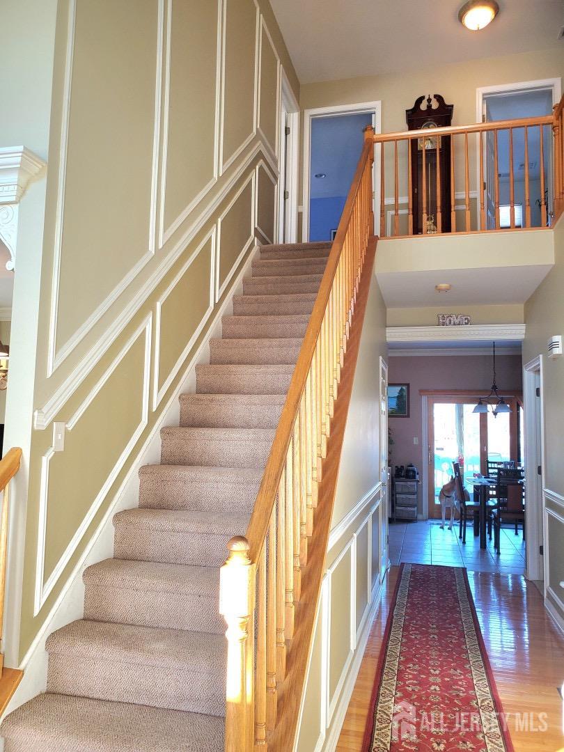 14 Young Way Bridgewater, NJ 08807 - Photo 24 of 38 a view of staircase with lots of frames on wall and a dining table