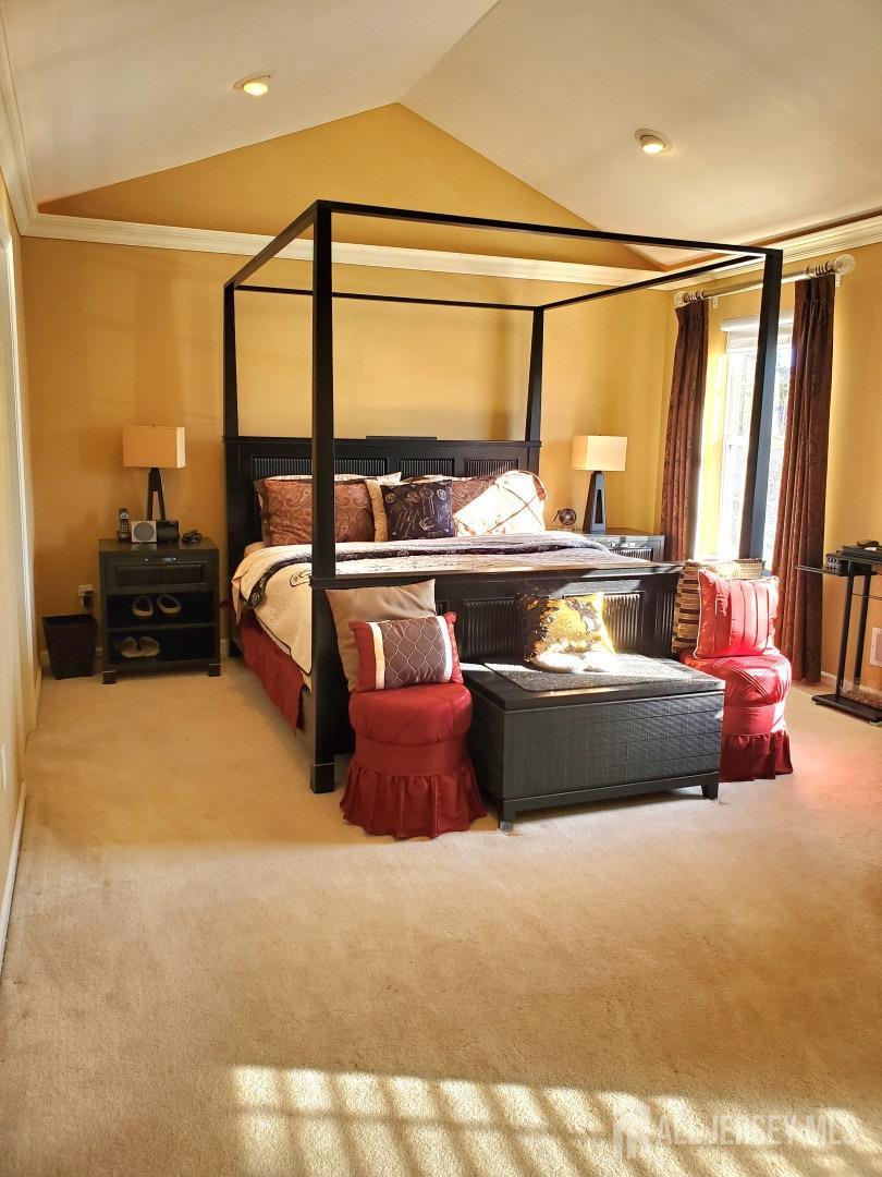 14 Young Way Bridgewater, NJ 08807 - Photo 26 of 38 a bed sitting in a room next to a lamp