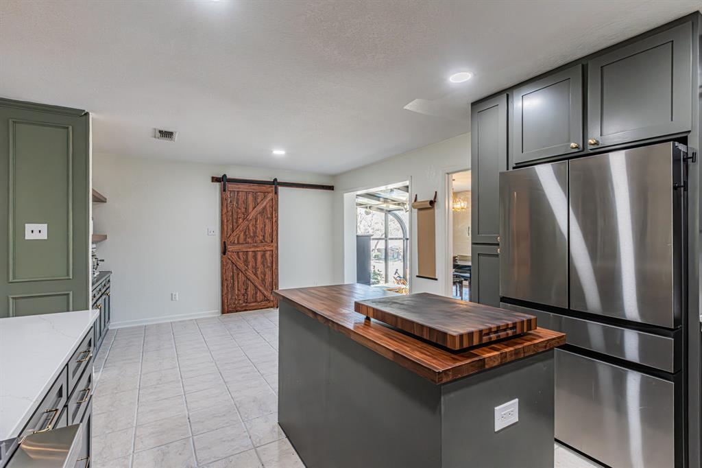 18 Crosslands Road Benbrook, TX 76132 - Photo 15 of 39 Barn door leads to Utility Room.