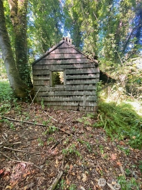 11000 Xx State Highway Northeast Bainbridge Island, WA 98110 - Photo 2 of 16 a front view of a house with a yard