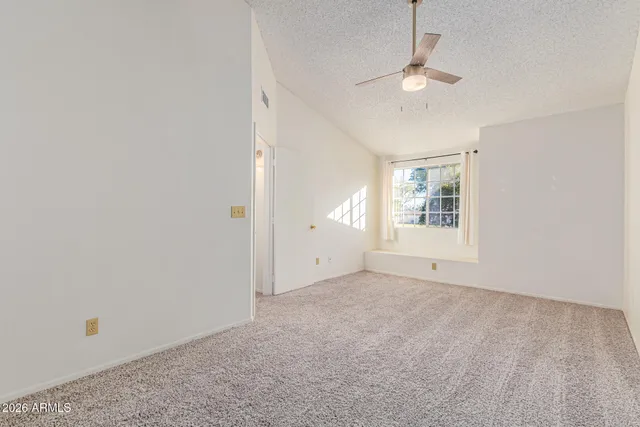 a view of a room with closet and a ceiling fan