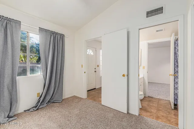 a view of a kitchen with white cabinets