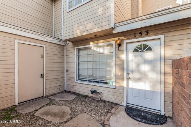 a view of an empty room with a bathroom and a window