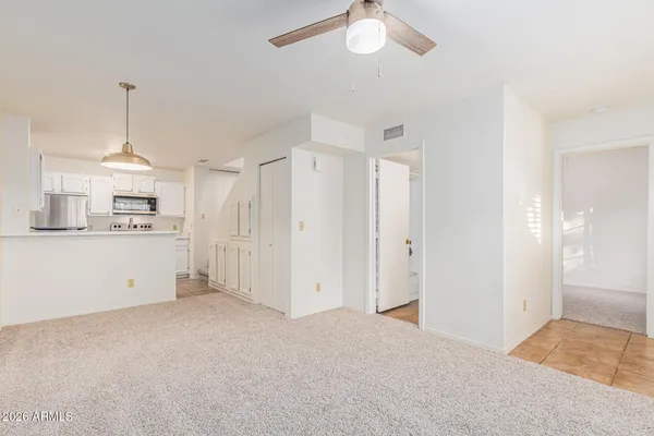 a kitchen with white cabinets and white appliances