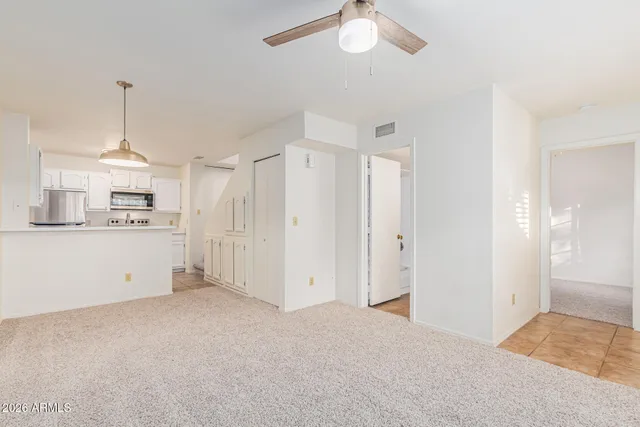 a kitchen with white cabinets and white appliances