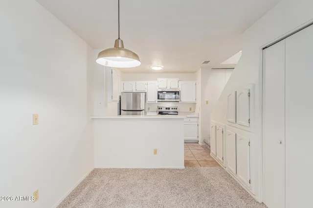a kitchen with stainless steel appliances a sink stove and refrigerator