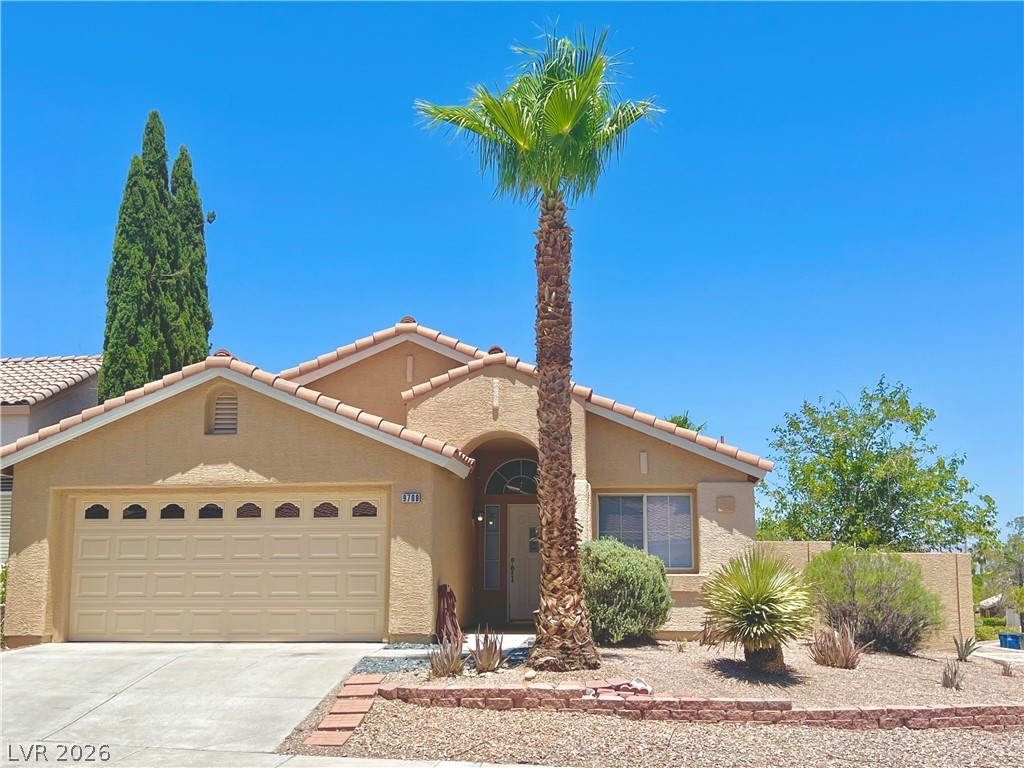 9708 Ridge Creek Place Las Vegas, NV 89134 - Photo 43 of 43 A terracotta-tiled roof crowns this stucco residence, featuring a two-car garage and drought-resistant landscaping.