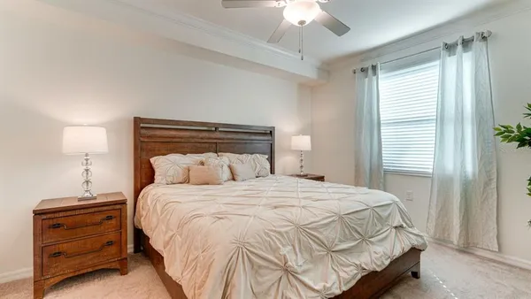 a bedroom with a bed and a chandelier