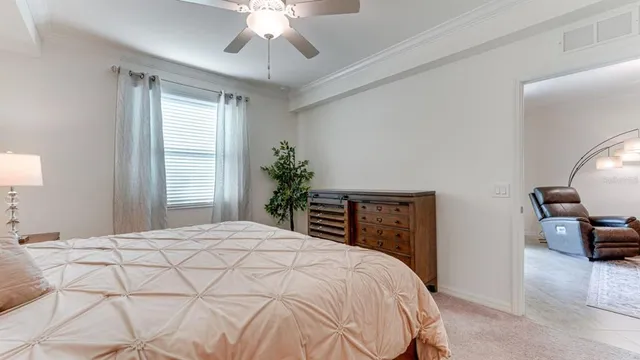 a bedroom with a large bed and a chandelier