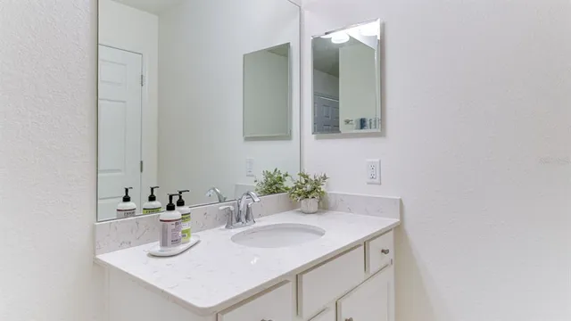 a bathroom with a sink and a mirror