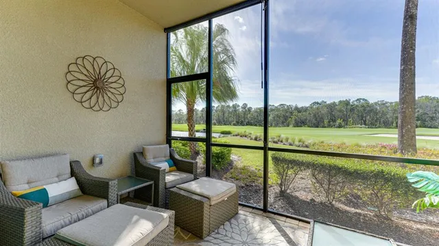 a view of a porch with furniture and garden