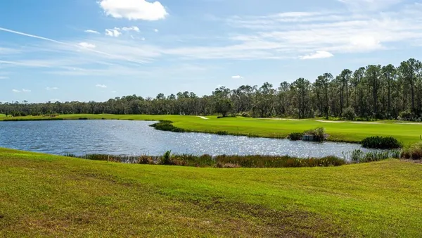 a view of a golf course with a lake