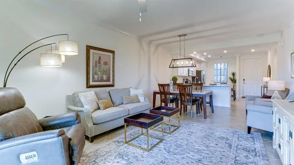 a living room with furniture and a chandelier