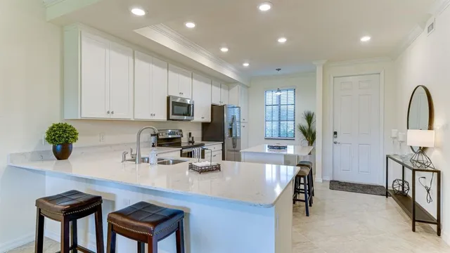 a kitchen with kitchen island granite countertop a sink and counter space